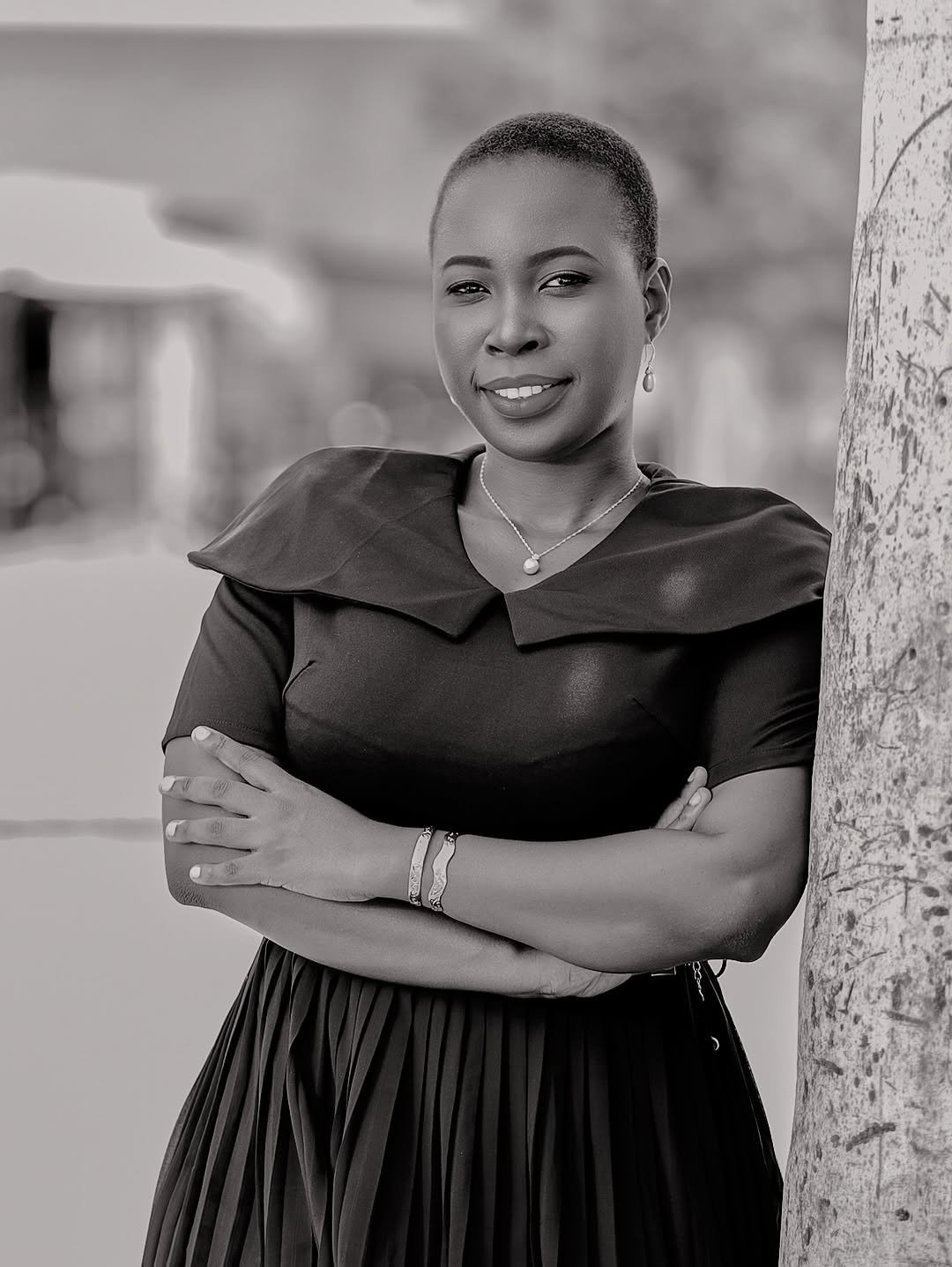 Black and white portrait of Jennifer Shigoli, arms folded, outdoors
