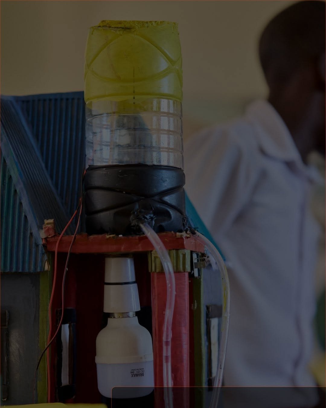 A device made by students from a water bottle and wires, in a classroom at Tuwapende Watoto, Bunju B
