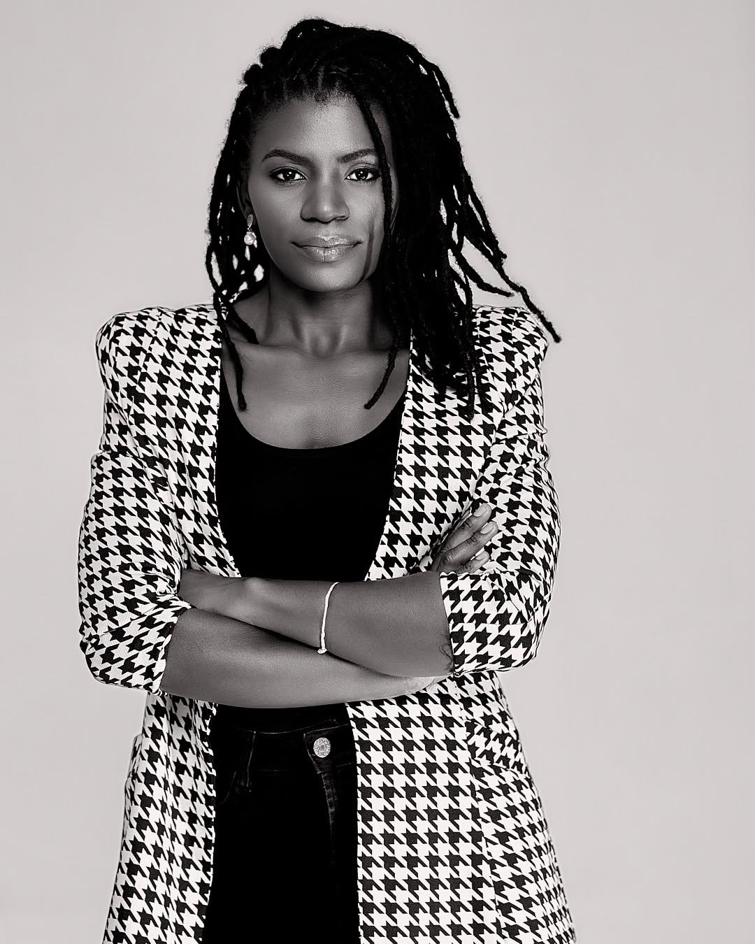 Studio portrait of a woman in a houndstooth jacket